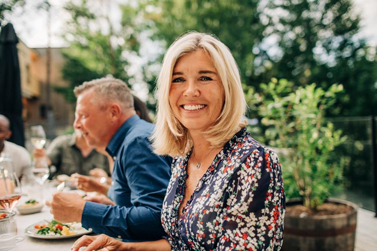 A woman in a flowery dress at lunch